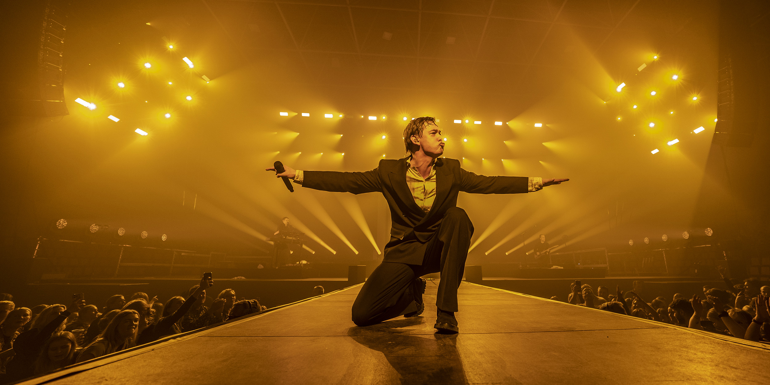 singer-on-stage-bathed-in-orange-light.jpeg