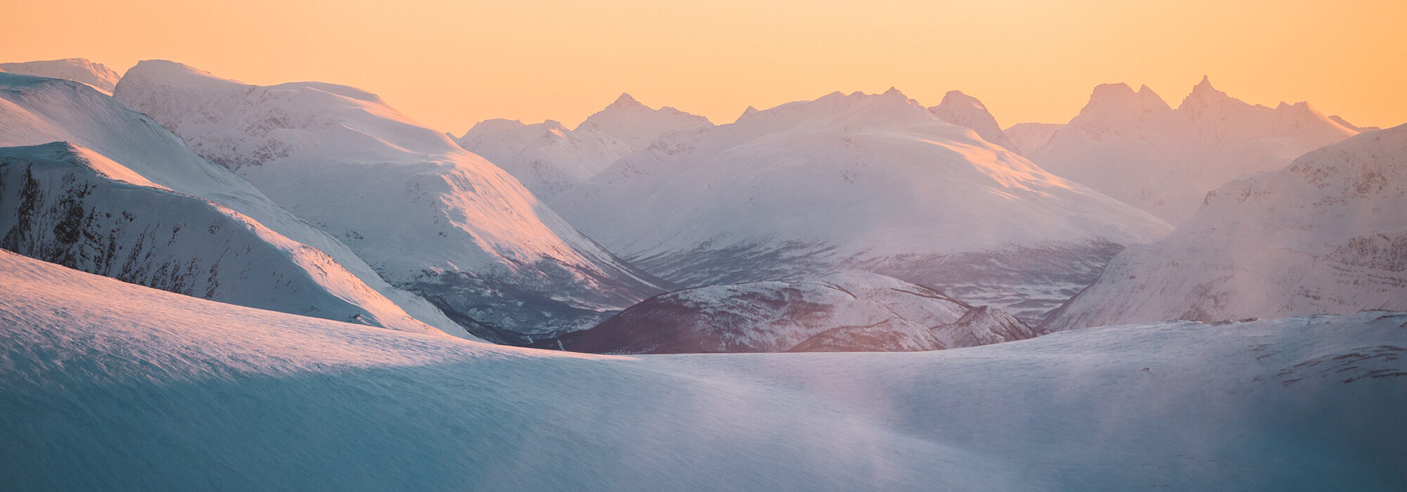 sunrise-over-snow-covered-mountains-2000x700-1_landscape_2000x700.jpeg